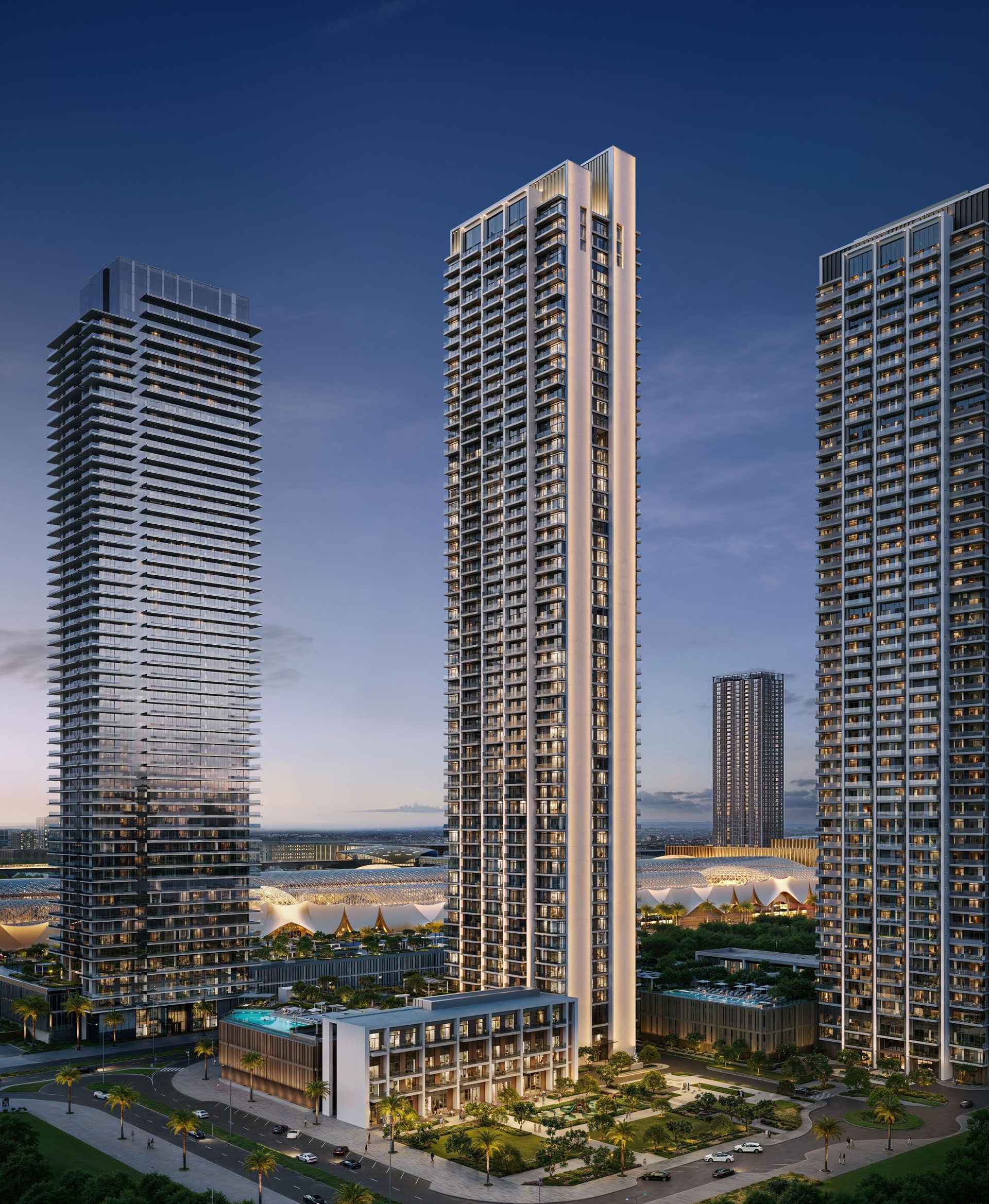 Valia tower rising above its mixed-use podium at night
